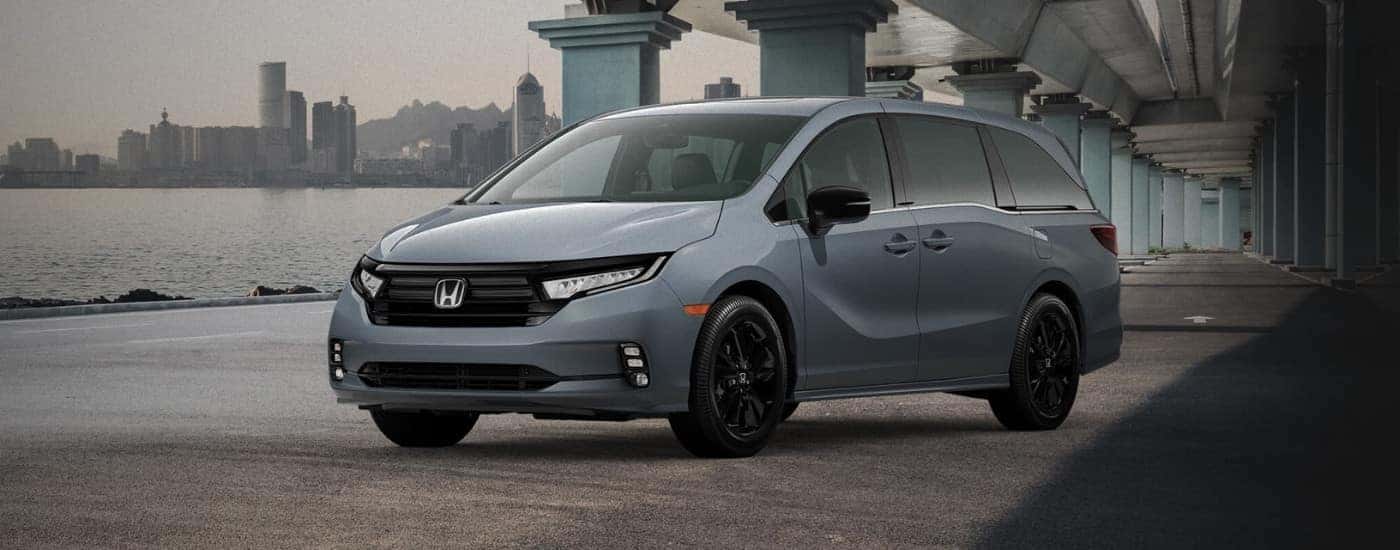 Grey 2023 Honda Odyssey parked under a bridge