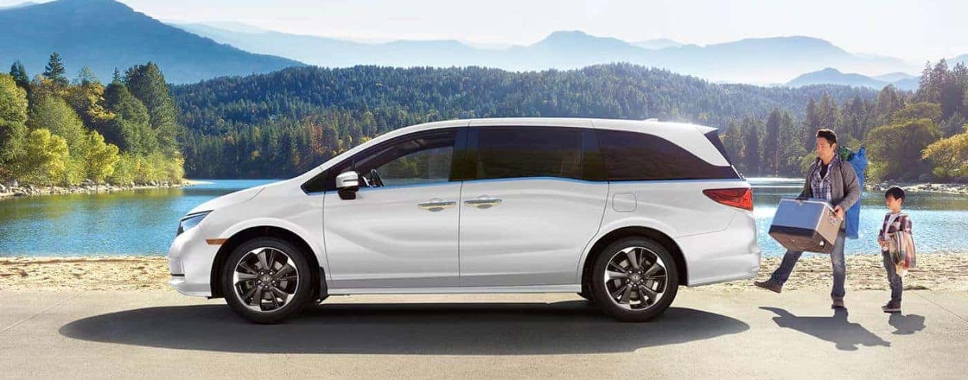 White 2023 Honda Odyssey parked by a lake