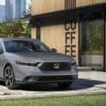 A gray 2026 Honda Accord Hybrid parked near a coffee shop.