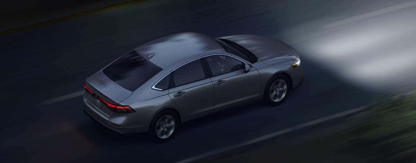 Grey 2026 Honda Accord driving on a highway at night