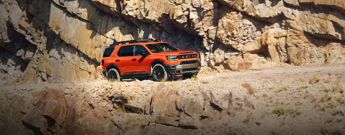 Orange 2026 Honda Passport parked off-road