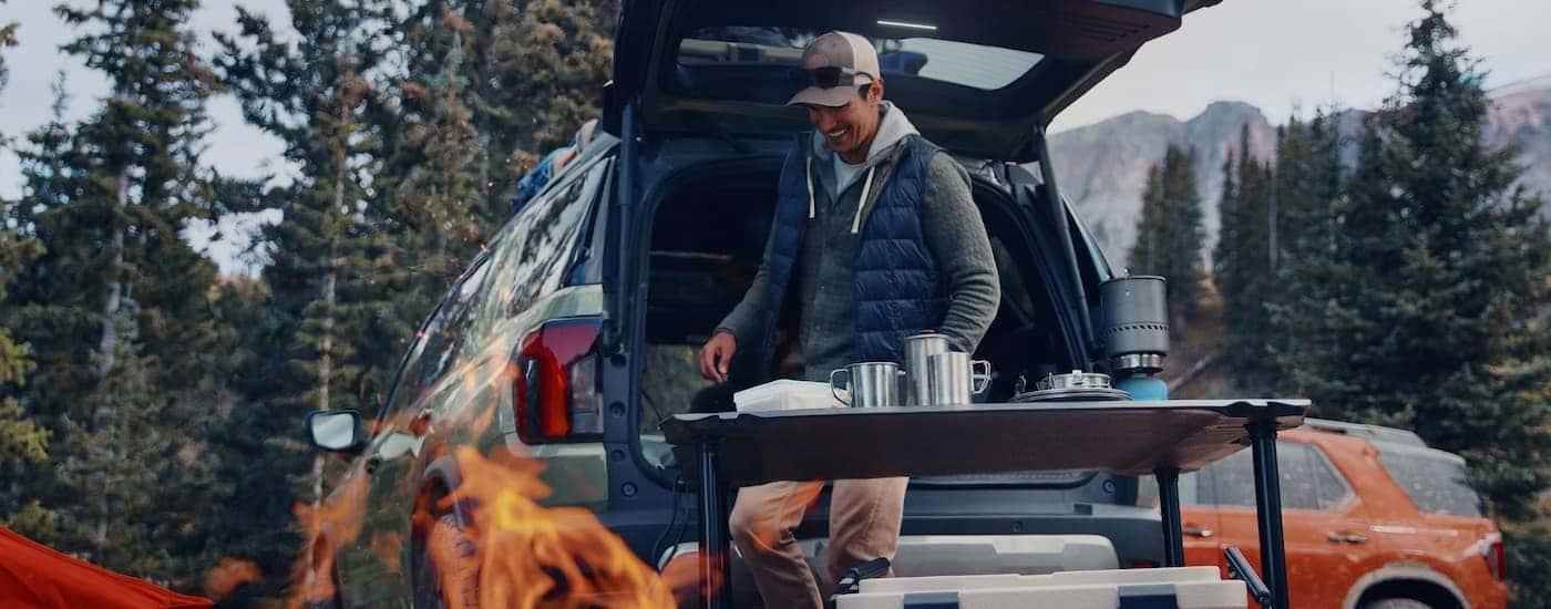Man camping with a grey 2026 Honda Passport