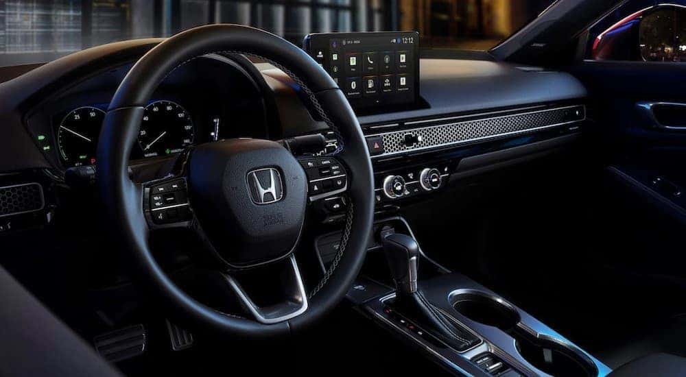 Black dash in a 2026 Honda Civic Hybrid for sale.