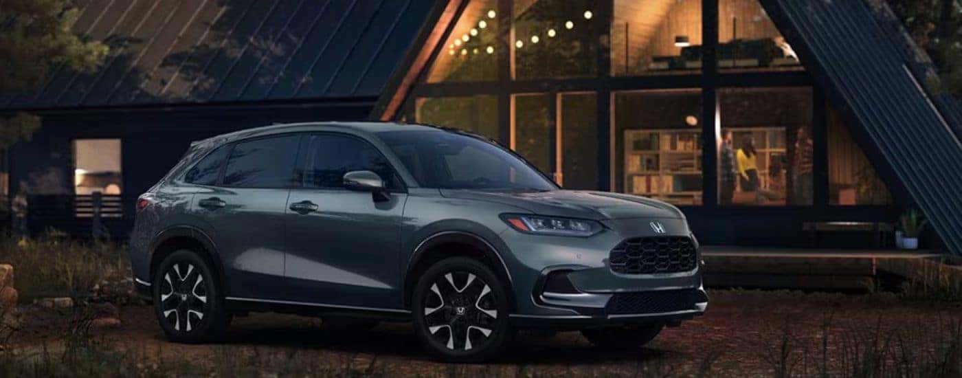 Green 2026 Honda HR-V EX-L parked in front of a cabin