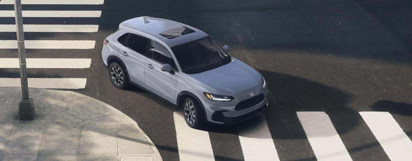Grey 2026 Honda HR-V EX-L turning through an intersection