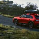 Red 2026 Honda HR-V Sport driving on a dirt road