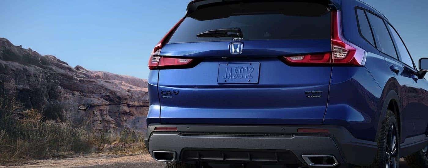 Rear view of a blue 2026 Honda CR-V Hybrid close up.