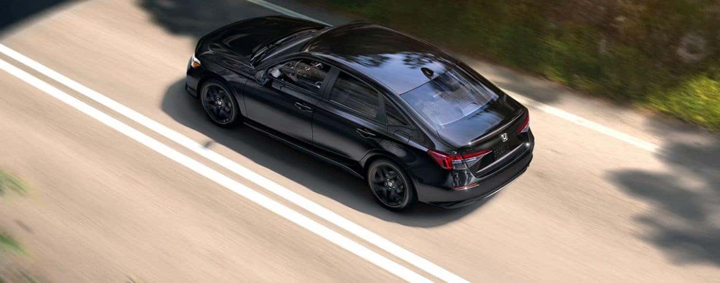 Black 2026 Honda Civic aerial rear view while driving.