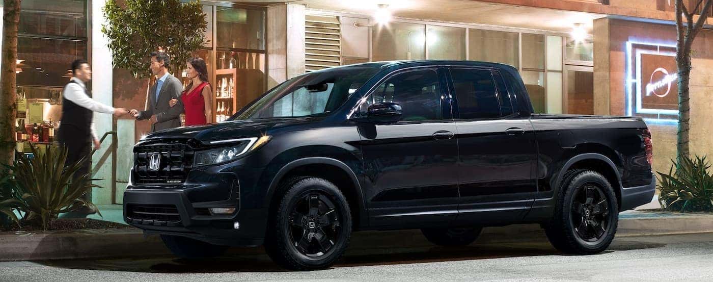 A black 2026 Honda Ridgeline parked in a city.