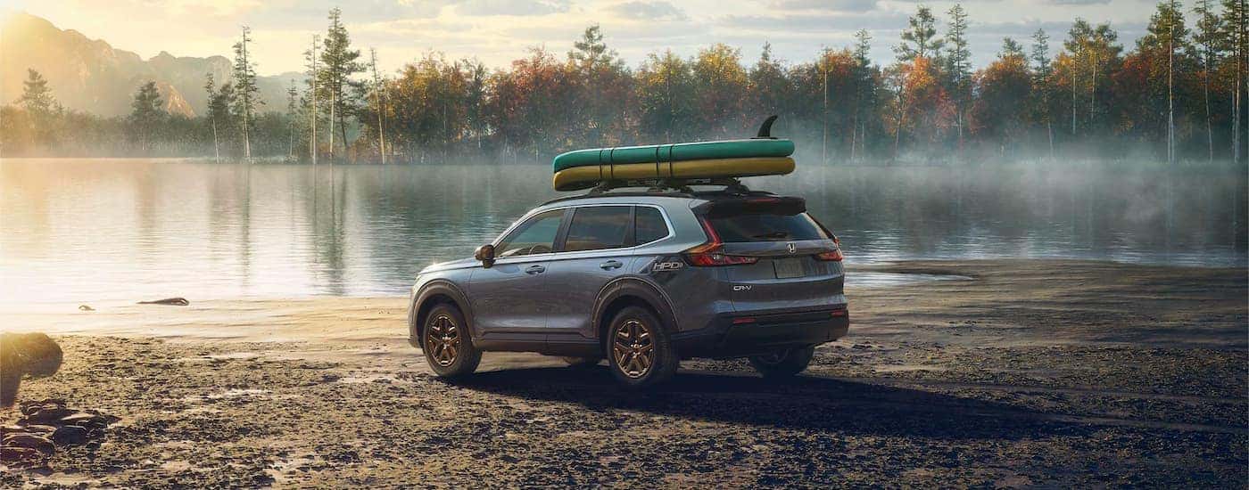 Grey 2023 Honda CR-V HPD parked near a lake.