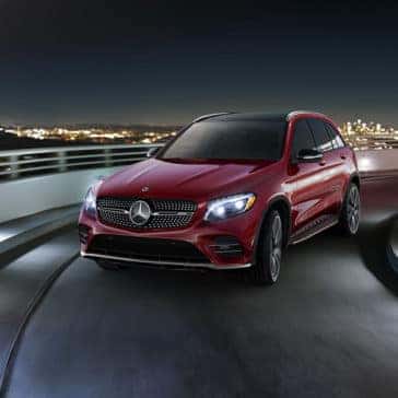 Red 2018 Mercedes-Benz GLC driving on a road at night