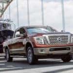 Red Nissan Titan XD Towing Gigantic Boat