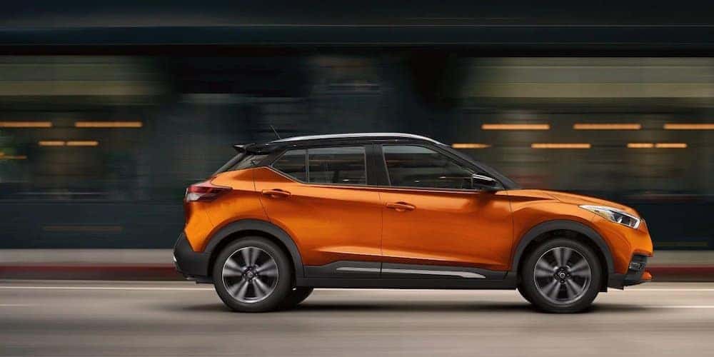Orange 2019 Nissan Kicks Driving Through City