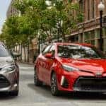 Two Toyota Corollas side-by-side at intersection