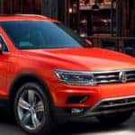 2018 Orange Volkswagen Tiguan parked curbside in the city