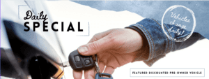 Daily Special Featured pre-owned vehicle discount special is written on top of a photograph of a person putting a key into their vehicle