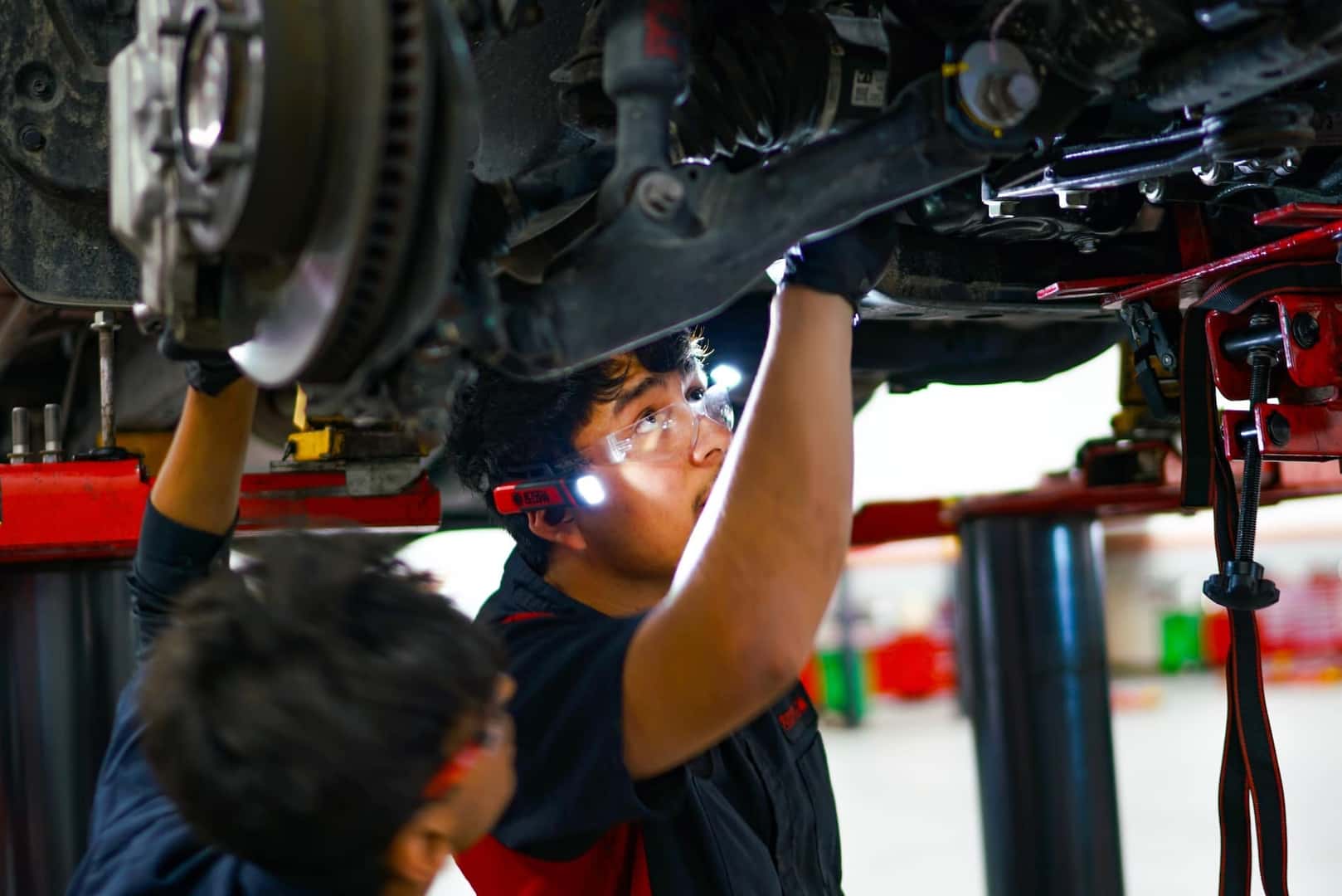technician replacing oil in vehicle