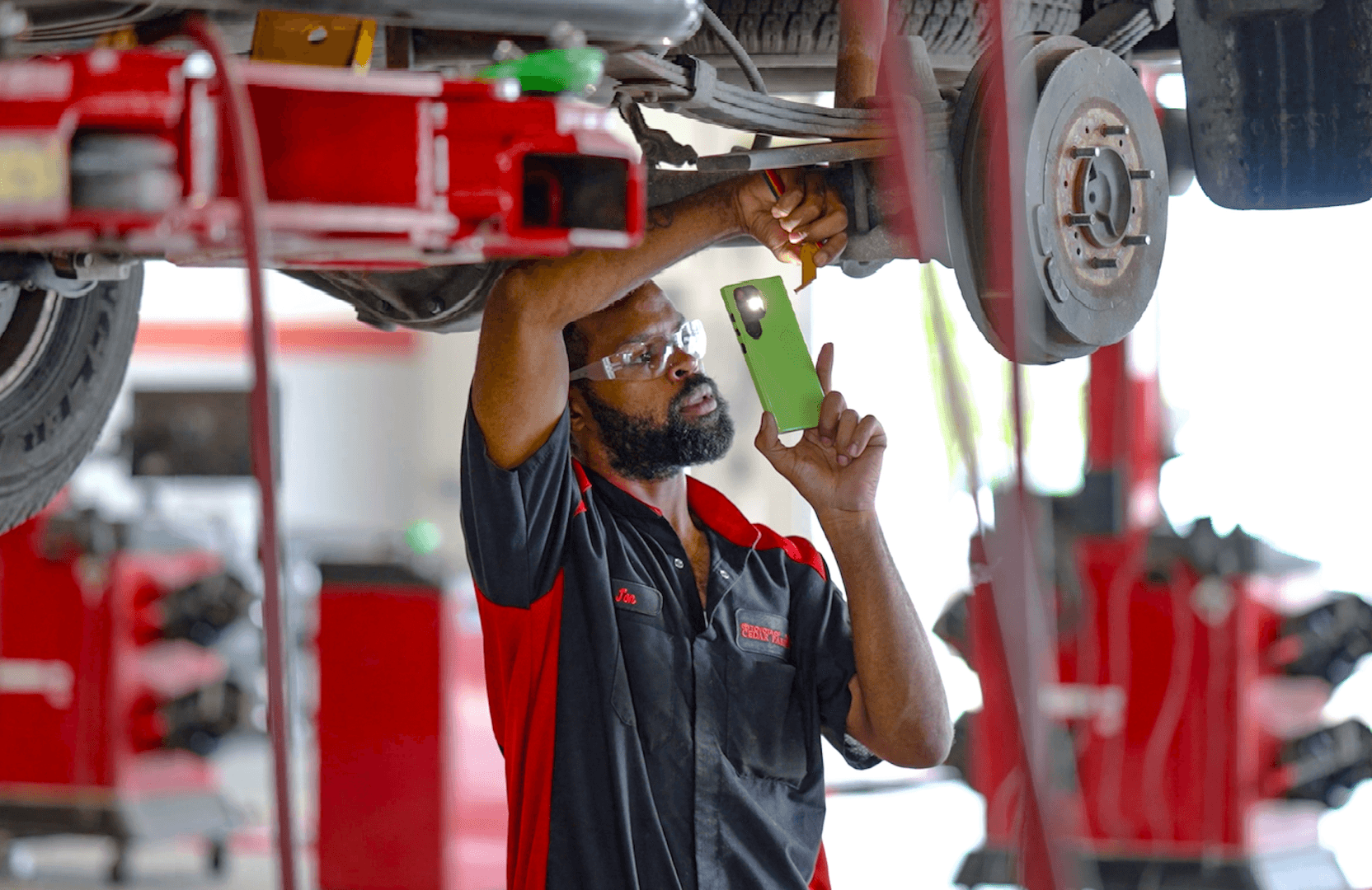 technician fixing underneath of vehicle