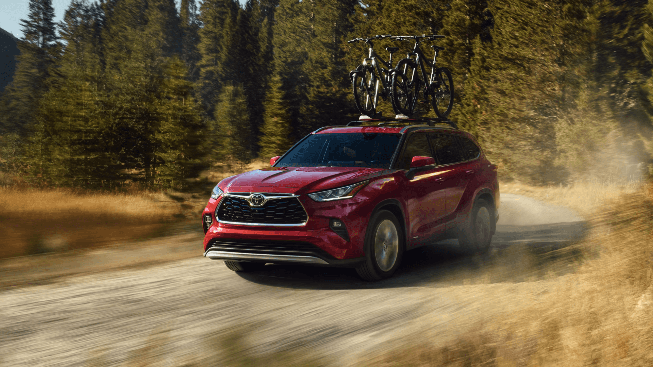 Red 2026 Toyota Highlander with bicycle roof rack Near Austin, TX