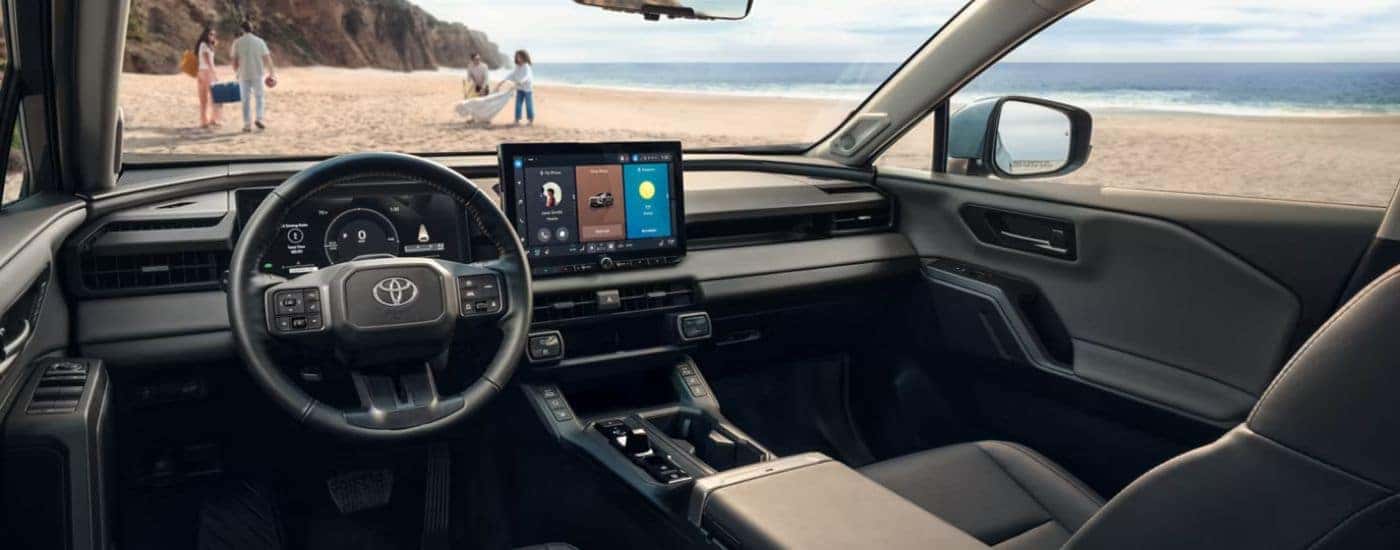 The front interior and dashboard with infotainment display on a 2026 Toyota RAV4.