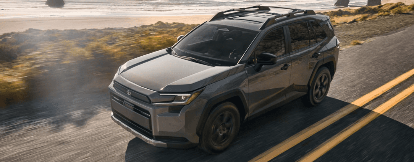 Grey 2026 Toyota RAV4 driving along a a beach