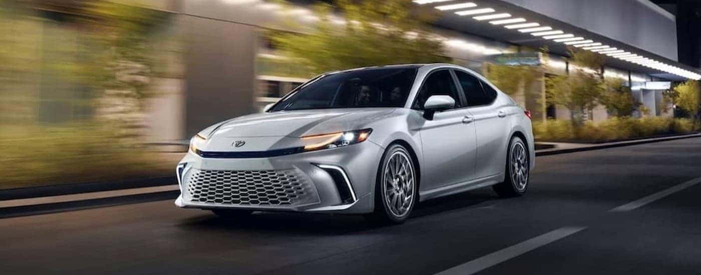 A silver 2026 Toyota Camry driving in a city.