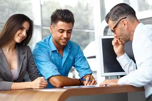 Couple looking at options for buying a car