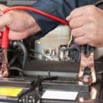 Mechanic jump starting a car