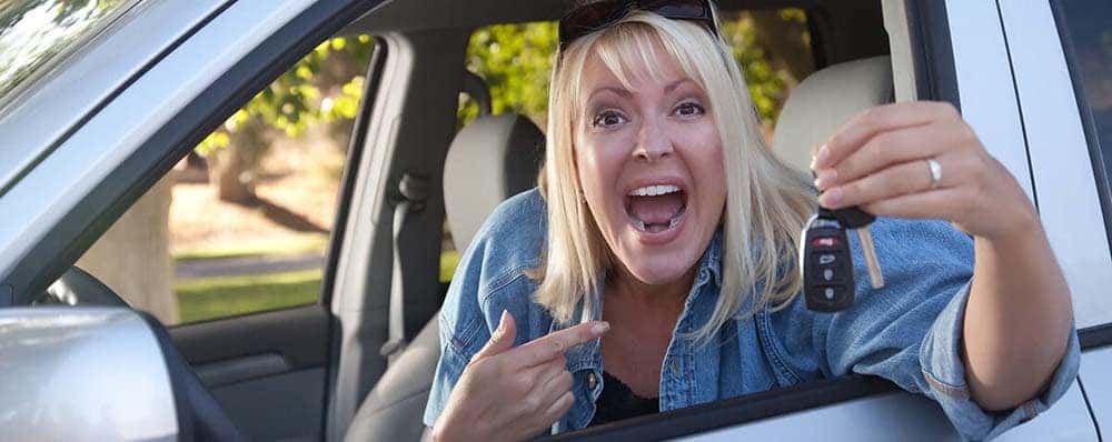 Excited woman increases trade-in value on her used car