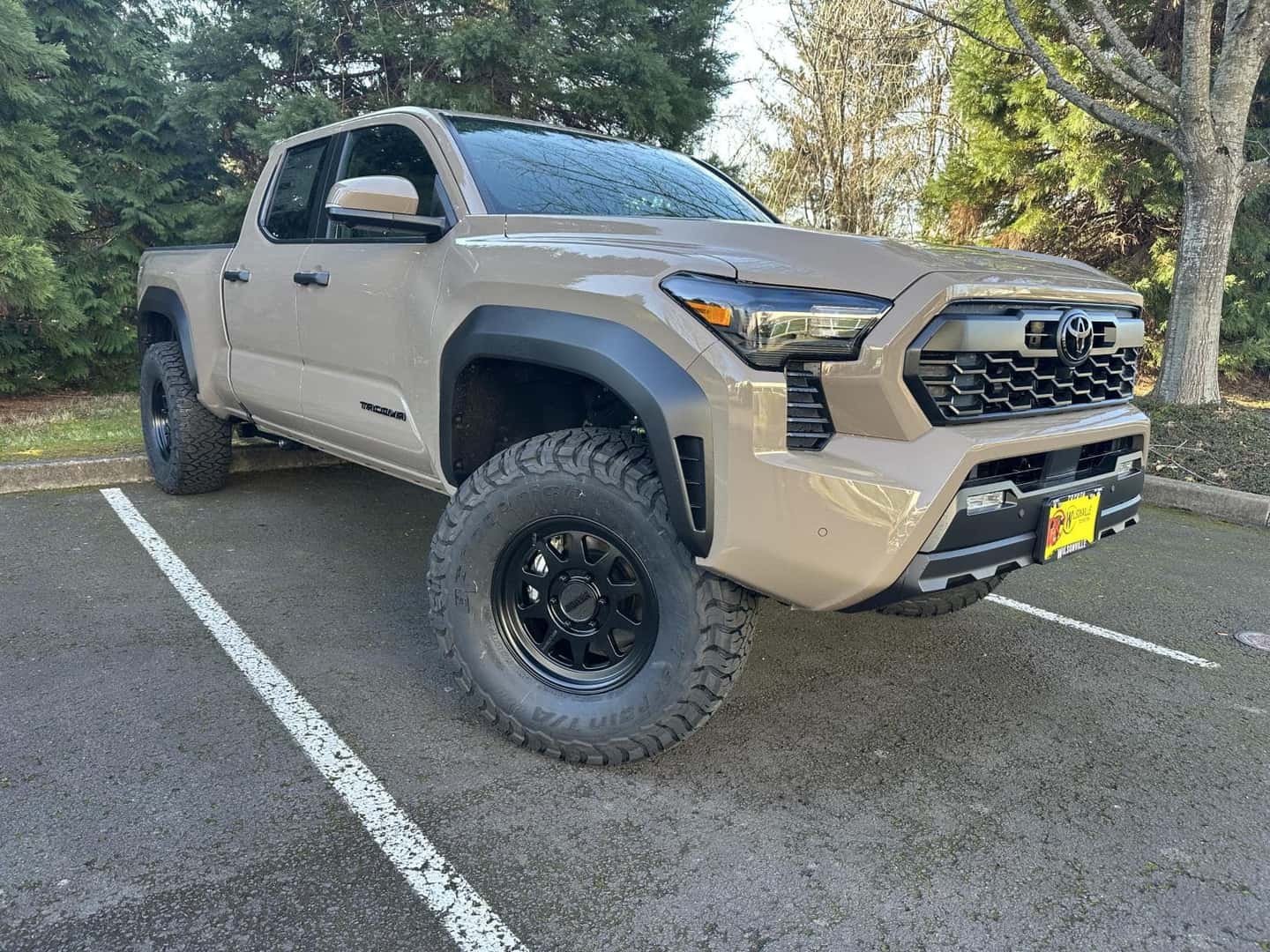 Custom wheels and all-terrain tires on a Toyota